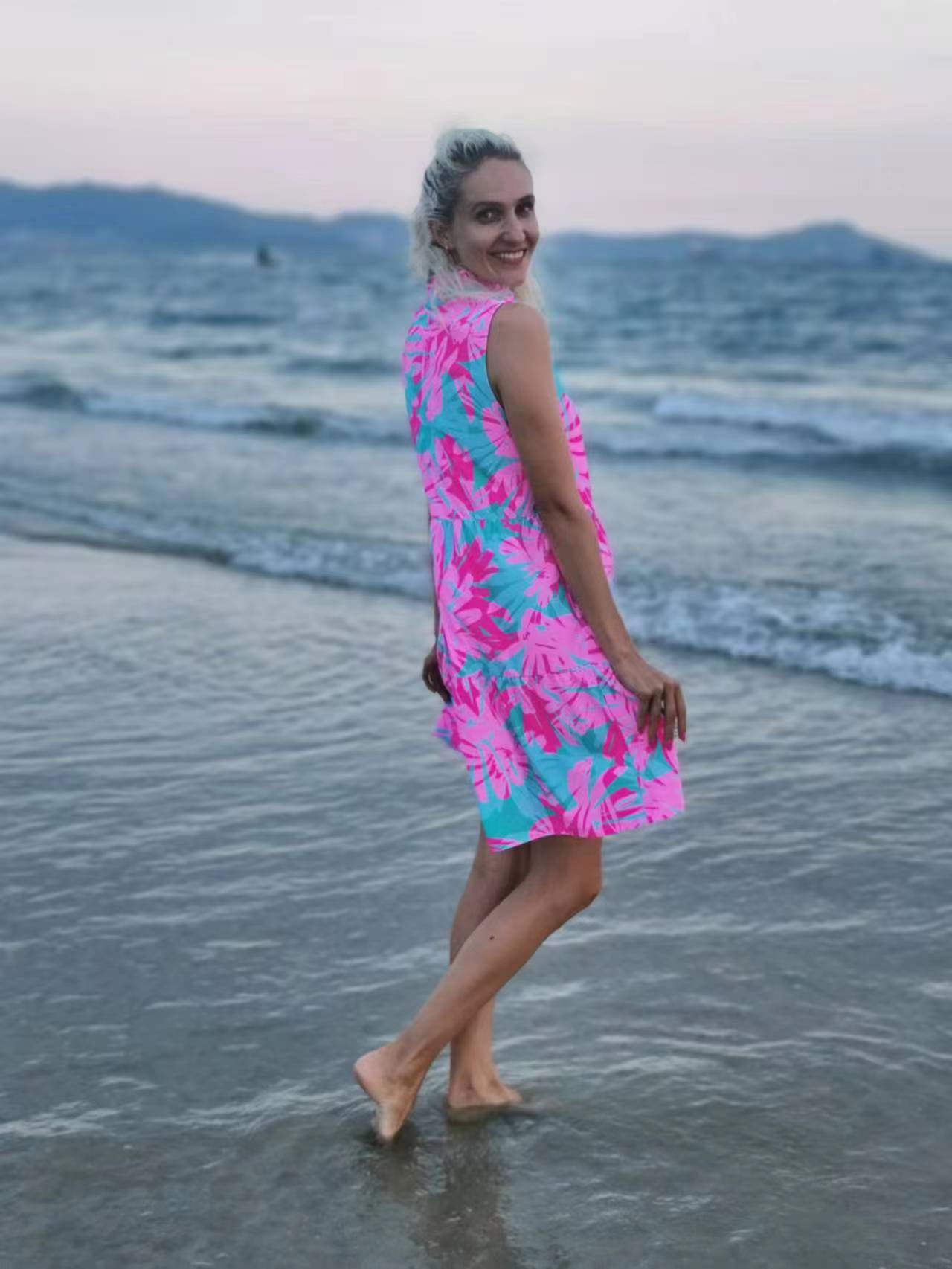 Woman in Summer Beach Swim Dress standing on a beach, showcasing its versatile swimsuit fabric designed for comfort and style.