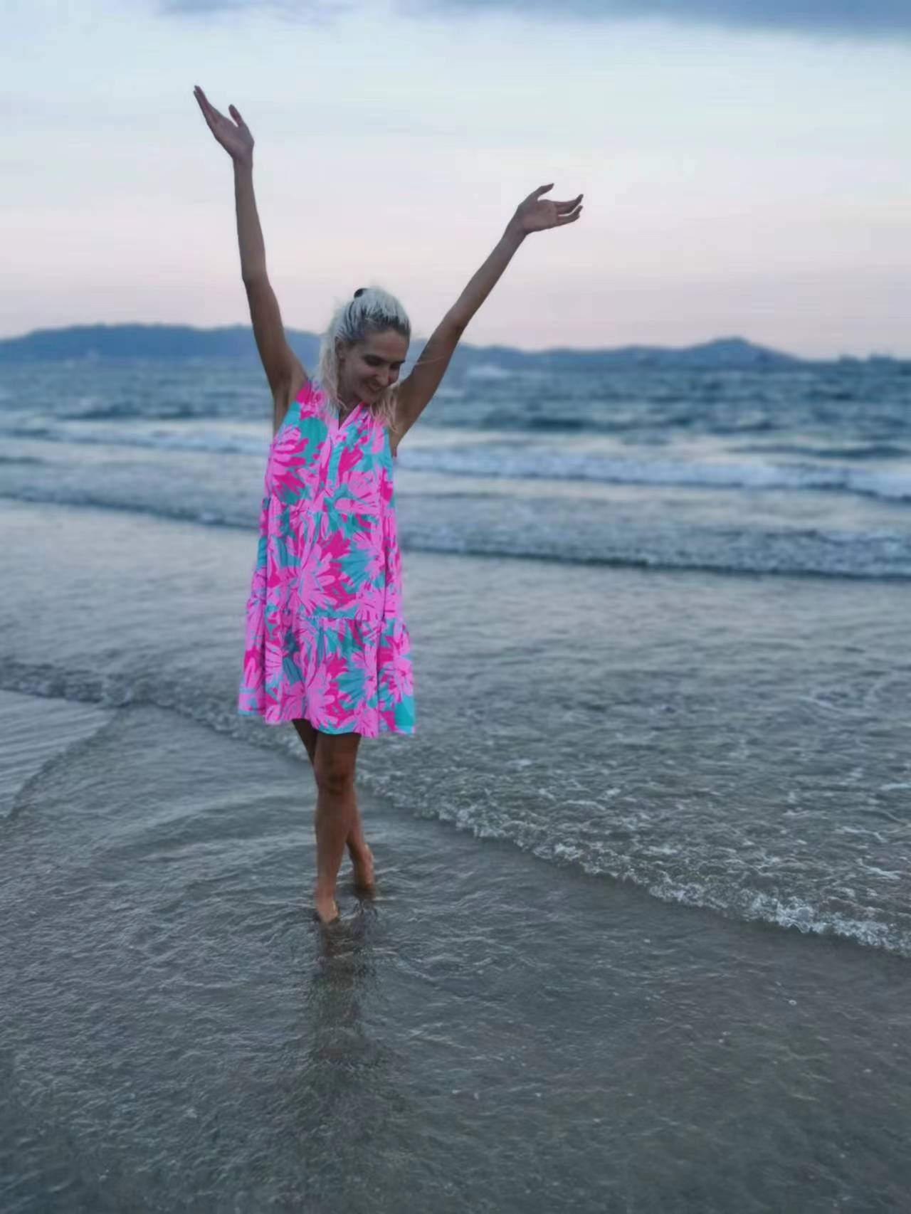 Woman standing on a beach, wearing the Summer Beach Swim Dress made from versatile swimsuit fabric, ideal for seamless day-to-night transitions.