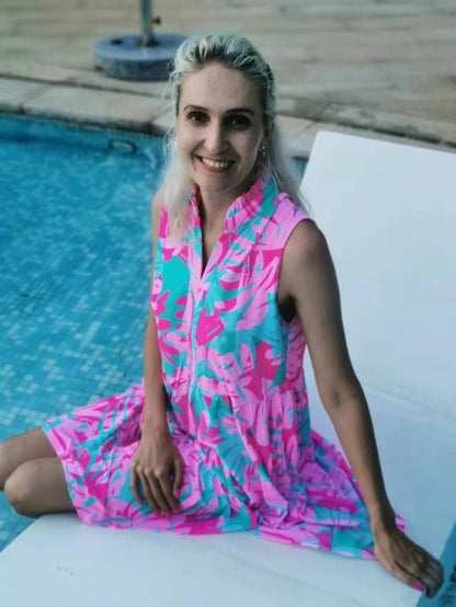 Woman in a Summer Beach Swim Dress sitting by a pool, smiling, showcasing the dress's comfort and versatility for beach or evening wear.